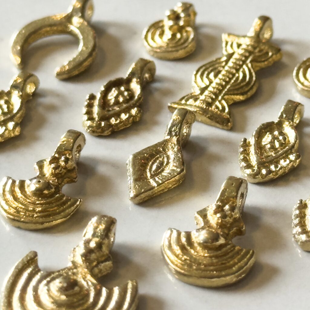 Multiple styles of brass pendants zoomed in for macrame jewelry