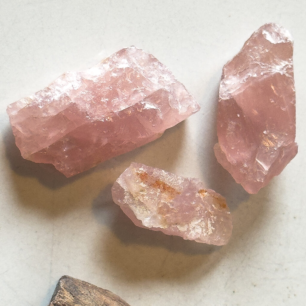 Rose quartz crystals on display used for handmade macrame jewelry designs